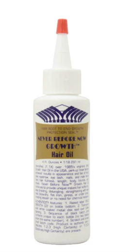 Bottle of hair oil with a white label on a white background